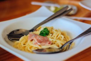 Spaghetti Dishes with Creamy Sauce and Ham on a plate