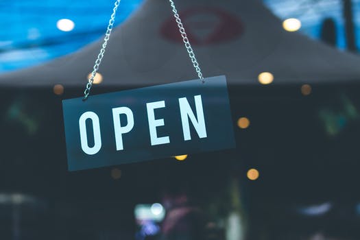 An "Open" sign hanging on a chain is one that is commonly found in restaurants in London